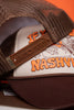 Brown and beige cap with 'Nashville' text on an orange background
