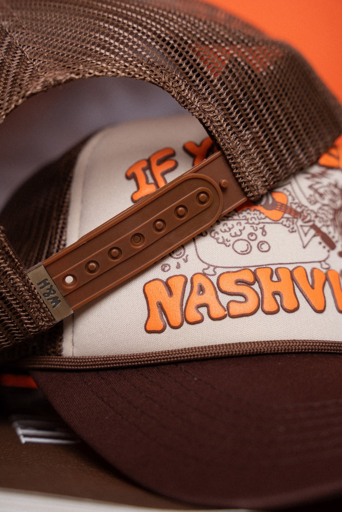 Brown and beige cap with 'Nashville' text on an orange background