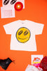 White t-shirt with smiley face design on an orange background